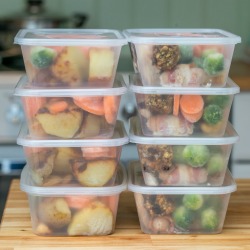 Meal prep. Stack of home cooked roast chicken dinners in containers ready to be frozen for later use as quick and easy ready meals.
